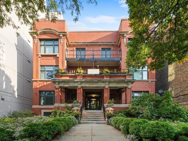 Red brick apartment building with landscaped entry walk